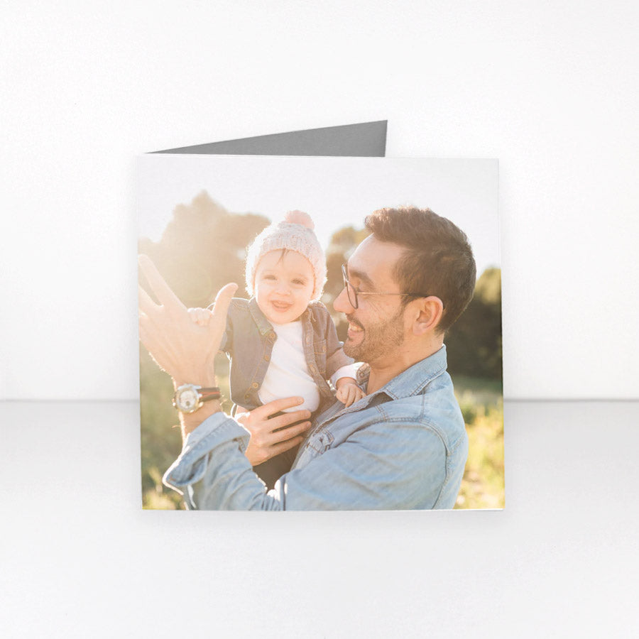 A folded personalised greeting card featuring a father and baby