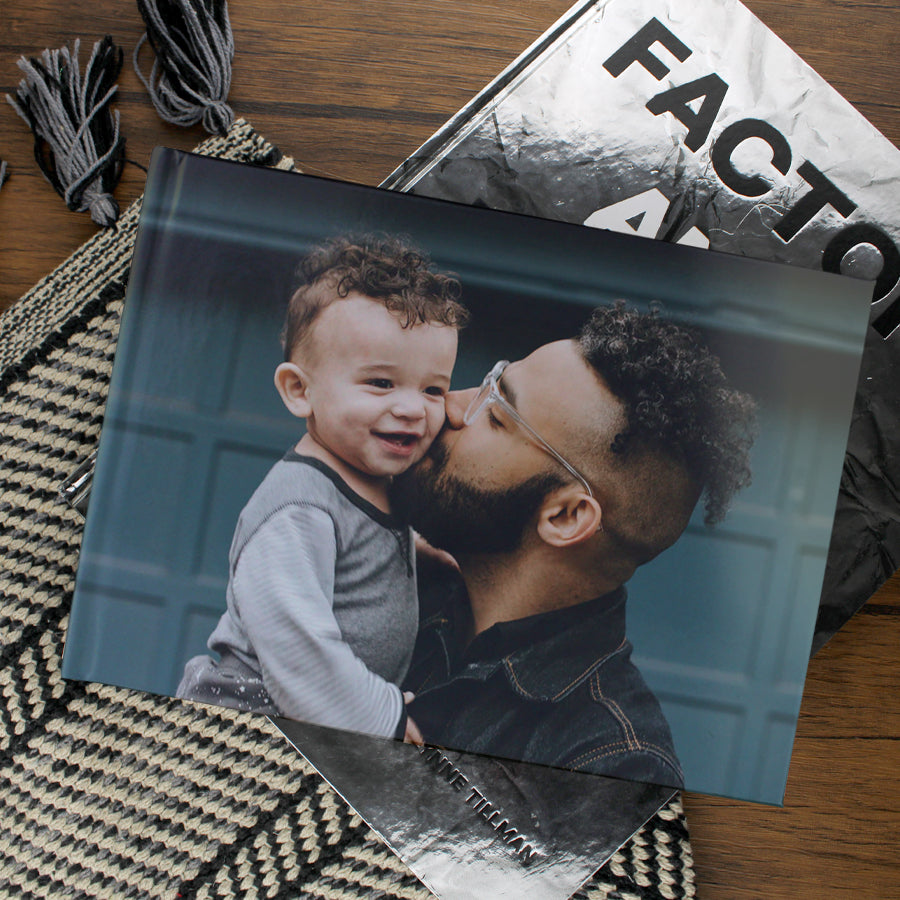 Lifestyle image of an A4 landscape hardcover personalised photo book printed in the UK using FSC-certified paper
