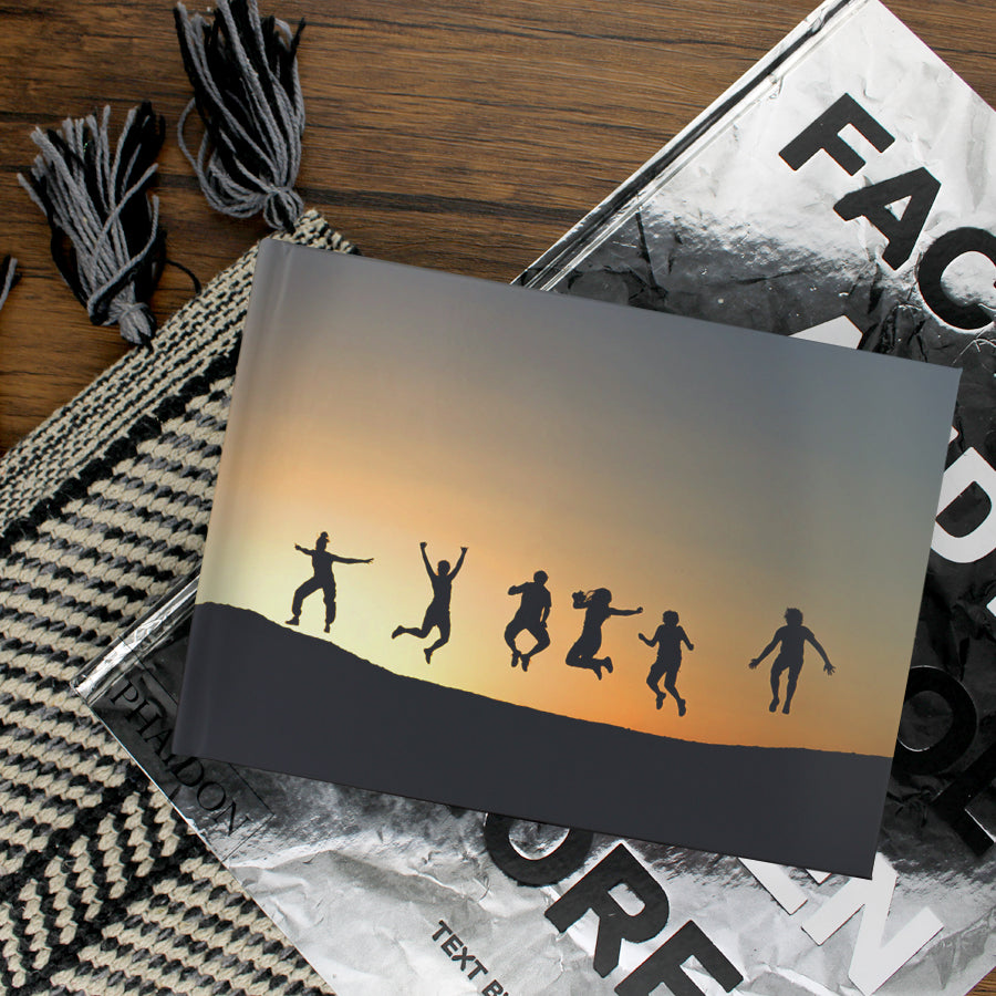 Lifestyle image of an A5 landscape hardcover personalised photo book printed in the UK using FSC-certified paper
