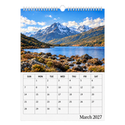 Picsme A3 single-page photo calendar showing snow-streaked mountains beside a lake and the March 2027 date grid with white Wire-O binding and a white hanger.