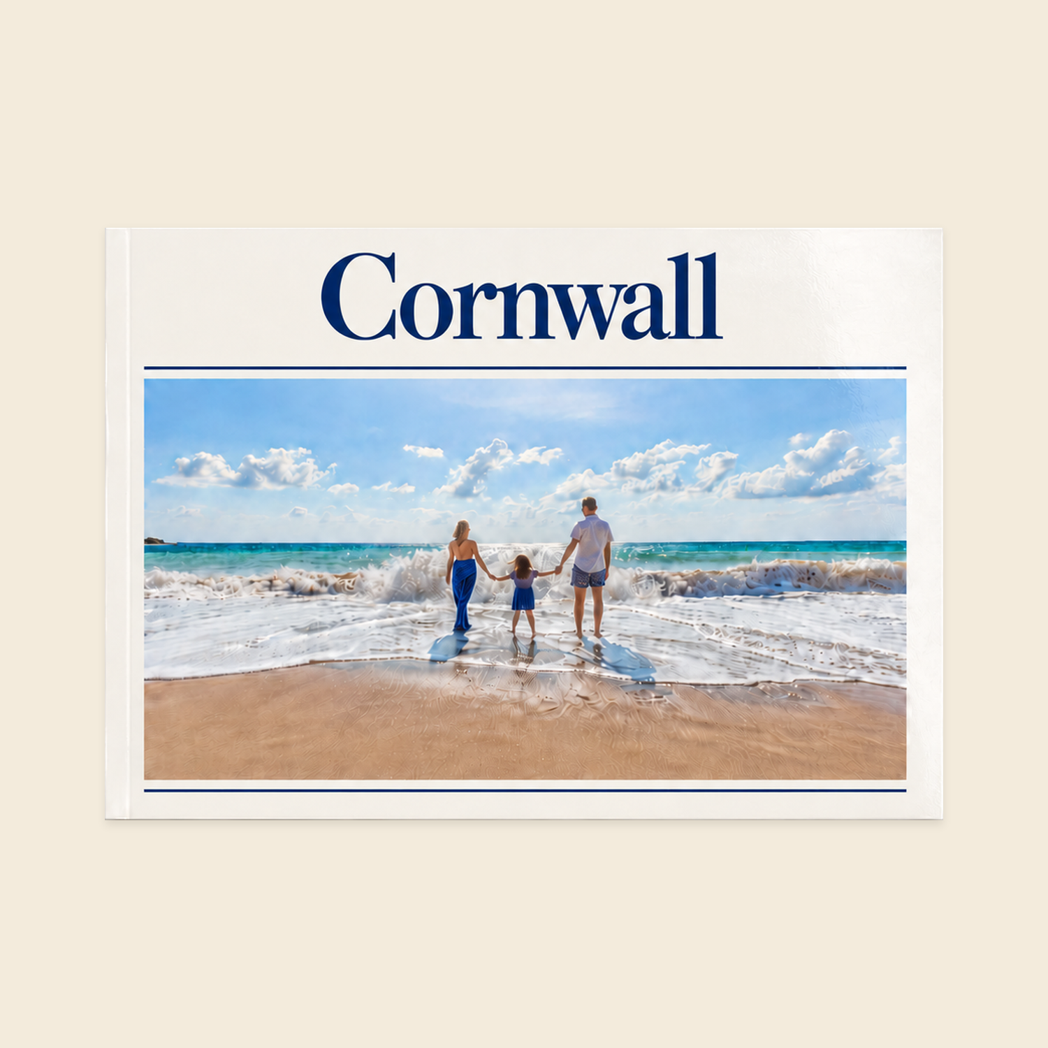 A4 landscape softcover photo book with a centred Cornwall title, navy rules and a photograph of a family holding hands at the beach.