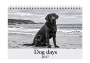 Picsme A5 double-page photo calendar with the Dog days 2027 cover, showing a black Labrador on a beach in black and white with white Wire-O binding.