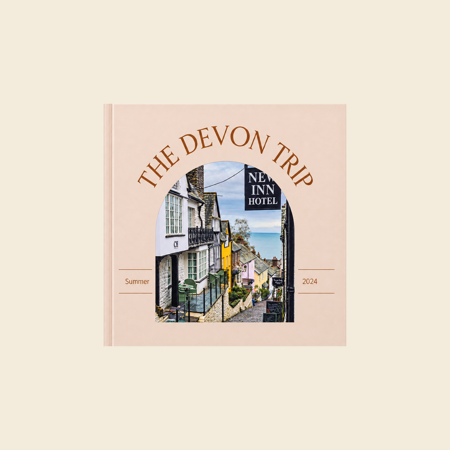 Picsme 200 mm square hardcover photo book with gloss paper, showing an arched Devon village photograph on a peach cover.